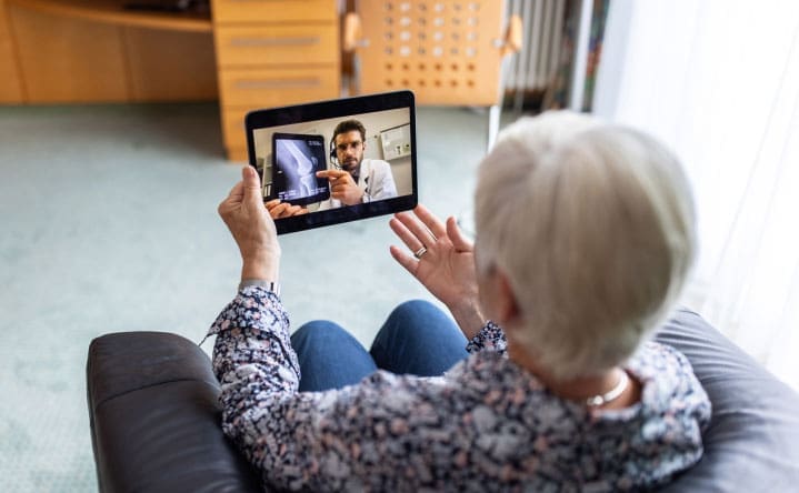 Elderly woman on a tele-health appointment via tablet